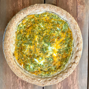 overhead shot of whole broccoli cheddar quiche