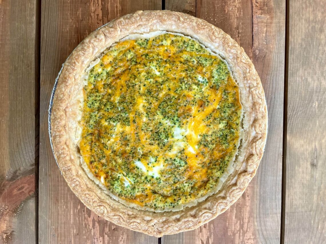 over head photo of whole broccoli cheddar vegetarian quiche