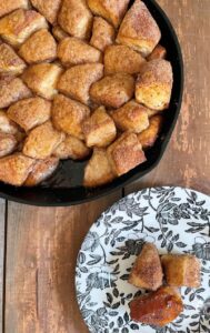 Monkey bread cooked in cast iron skillet served on plate