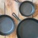 three cast iron skillets of different sizes